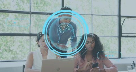 Business team collaborating over laptop with AI neural HUD overlay in bright office