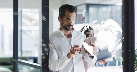 Modern Businessman Analyzing Global Digital Data on Tablet in Office
