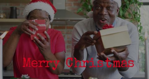 Joyful african american couple celebrating christmas with gifts