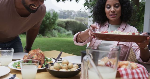 Friends Enjoying Outdoor Meal in Garden Setting - Download Free Stock Images Pikwizard.com