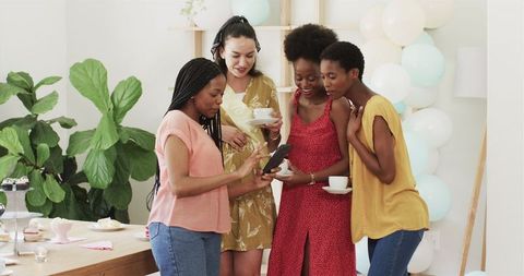 Diverse Friends Taking Selfie During Joyful Home Celebration