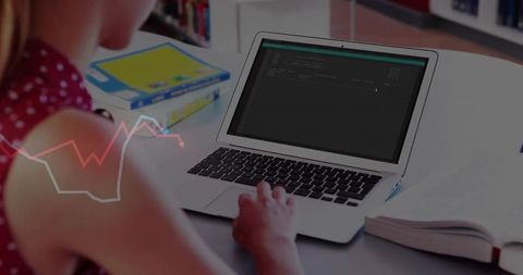 Teenage Student Coding on Laptop in Library Environment