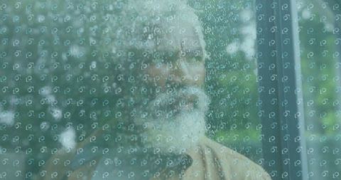 Bearded Man Gazing Through Rainy Window with Nature View
