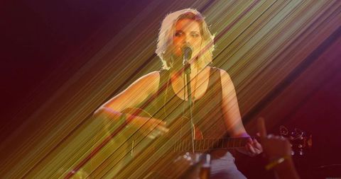 Teenage musician performing live acoustic set on stage