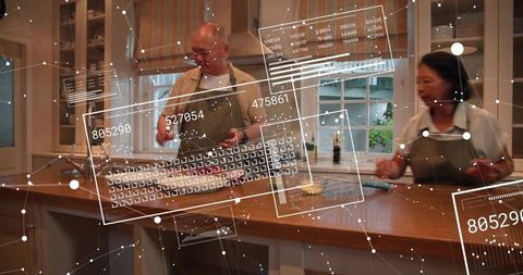 Mature couple preparing dinner with augmented reality panels over kitchen island