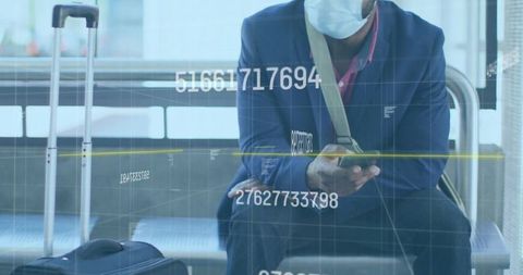 Business Traveler Wearing Mask Checking Phone at Airport