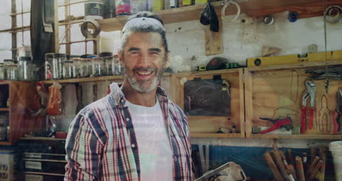 Happy Artisan Stands Proudly in Craft Workshop