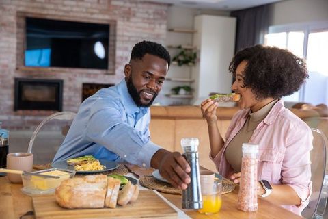 Couple Enjoying Breakfast with Avocado Toast at Rustic Table