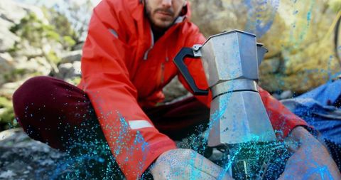 Hiker Preparing Coffee on Camping Stove in Scenic Landscape