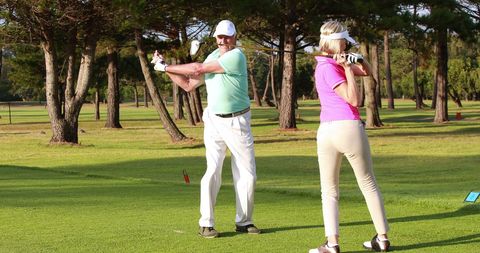Senior Golfers Enjoying Sunny Day on Golf Course with Lush Greenery - Download Free Stock Images Pikwizard.com