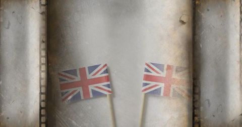 Vintage union jack flags on filmstrip background with grunge sepia texture and dust