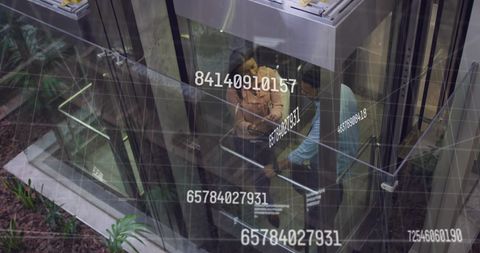 Digital data processing with diverse business team in elevator