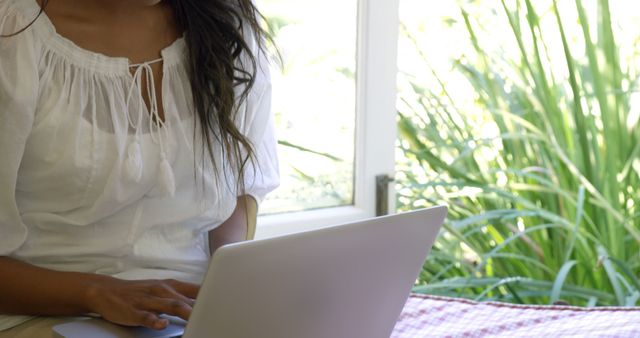 Woman Using Laptop in Bright Room with Green Plants - Download Free Stock Images Pikwizard.com