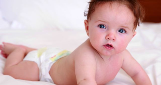 Adorable Baby with Curious Expression Crawling on Bed - Download Free Stock Images Pikwizard.com