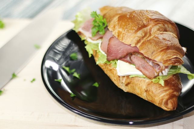Ham and Cheese Croissant on Black Plate - Download Free Stock Photos Pikwizard.com