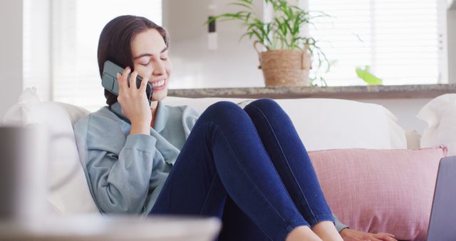 Young Woman Relaxing on Couch While Talking on Smartphone at Home - Download Free Stock Images Pikwizard.com