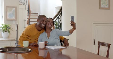 Smiling Couple Taking Selfie in Modern Kitchen