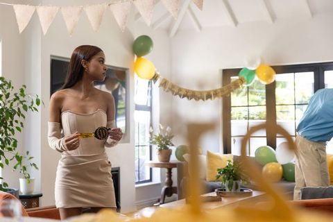 Woman Decorating for Birthday Party in Elegant Living Room