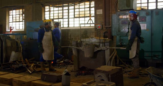 Industrial Factory Workers Operating Metal Casting Equipment - Download Free Stock Images Pikwizard.com