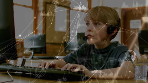 Young Boy Focused on Computer with Virtual Data Overlays
