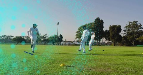 Cricket team sprinting through cone drills on sunlit grass training with digital overlay
