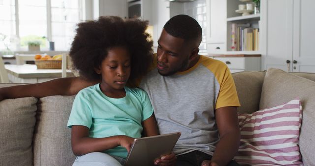 Father and Daughter Spending Time Home Reading Tablet Together - Download Free Stock Images Pikwizard.com