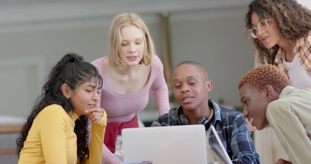 Diverse group of students collaborating on laptop project - Download Free Stock Images Pikwizard.com