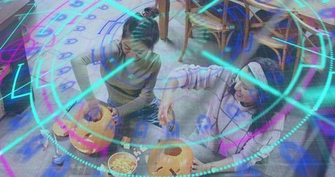 Carving pumpkins with augmented reality neon overlay for Halloween crafting together