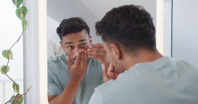 Man Inserting Contact Lenses in Front of Bathroom Mirror - Download Free Stock Images Pikwizard.com