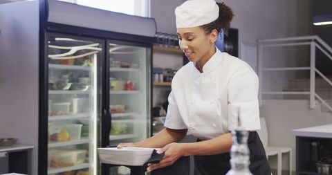 Professional Chef Handling Hot Dish in Modern Kitchen