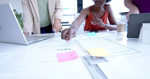 Creative Colleagues Collaborating with Notes and Technology in Office