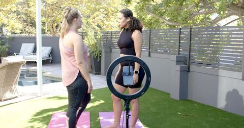 Outdoor yoga instructions with ring light by pool