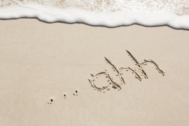 Ahh written on sand at beach