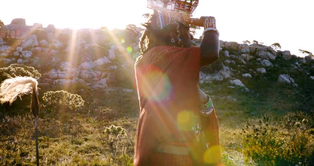 Maasai Warrior in Traditional Attire Carrying Basket in Morning Light - Download Free Stock Images Pikwizard.com