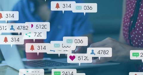 Typing hands on laptop with social notifications overlay for coworking productivity
