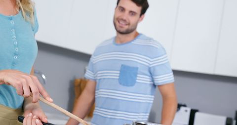 Couple Joyfully Cooking Together in Modern Kitchen
