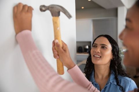 Diverse female friends collaborating in home improvement project