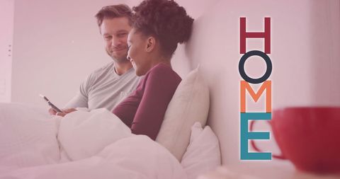 Interracial Couple Relaxing in Bedroom with Modern Home Text Overlay