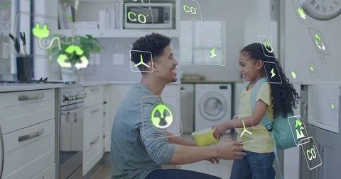 Father handing daughter bowl in eco-friendly kitchen with floating sustainability icons