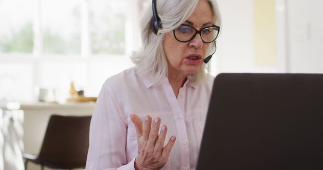 Senior Woman Wearing Headset Having Video Call at Home - Download Free Stock Images Pikwizard.com