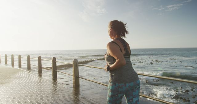 Woman Jogging by Ocean at Sunrise - Download Free Stock Images Pikwizard.com