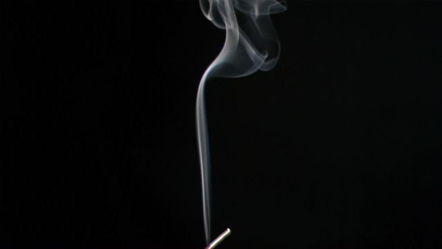 Smoke trails from a single match create an artistic, serene effect against a black background. It can be used for themes like fire safety, meditation, minimalism, and combustion studies. Ideal for educational materials, advertisements, and creative artistic projects.