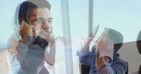 Multitasking Businessman Celebrating Success with Team