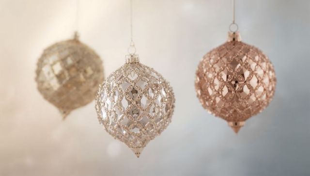 Hanging metallic filigree baubles in champagne, rose gold and silver with soft bokeh glow