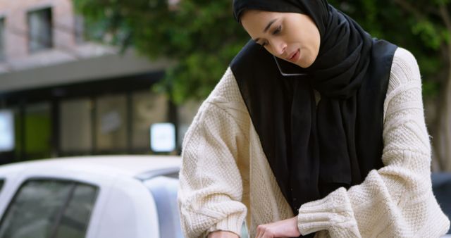 Businesswoman in Hijab Multi-tasking with Phone and Laptop Outdoors - Download Free Stock Images Pikwizard.com