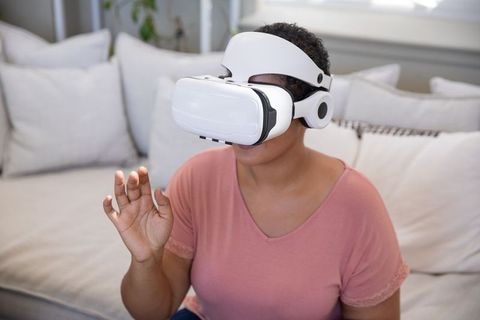Woman Engaging with Virtual Reality in Modern Living Room