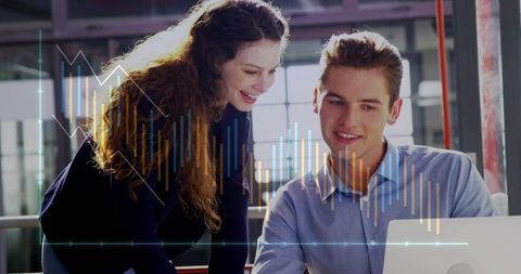 Young professionals collaborating and analyzing business data on laptop with chart overlay