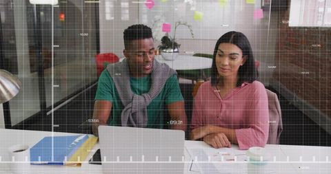 Team Analyzing Data Together on Laptop in Contemporary Office