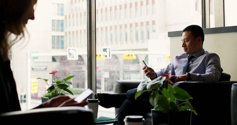 Businessman Using Mobile Phone in Modern Hotel Lobby - Download Free Stock Images Pikwizard.com