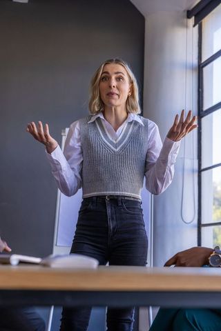 Confident businesswoman presenting in office meeting